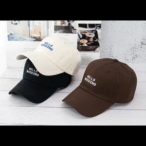 Detailed embroidery of HELLO WEEKEND text on cotton baseball caps in various colors