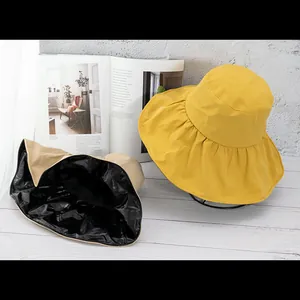 Detail view of wide-brim sun hat showing black UV protection coating inside
