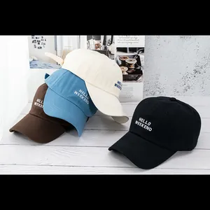 Detail of multi-color cotton baseball caps featuring Hello Weekend embroidery