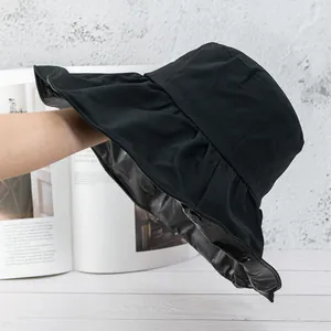 Detail of sun hat with black UV coating interior and ruffled brim for sun protection
