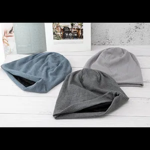 Detailed waffle knit texture and warm black lining of beanie hats in blue and grey