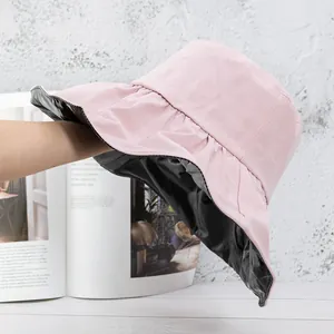Detail of wide brim sun hat showing the black UV protection coating and pink exterior