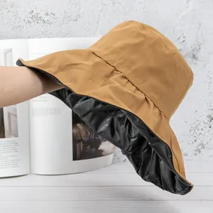 Detail of the sun hat showing the double-layer black UV lining and brown fabric texture