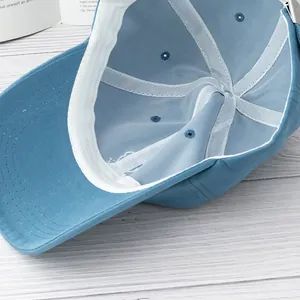 Detail view of light blue cotton baseball cap showing inner sweatband and metal buckle
