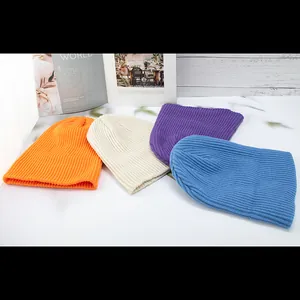 Minimalist ribbed knit beanies in orange, beige, purple, and blue for winter warmth