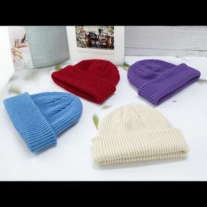 Flat lay of thick ribbed beanies in burgundy, purple, sky blue, and beige colors