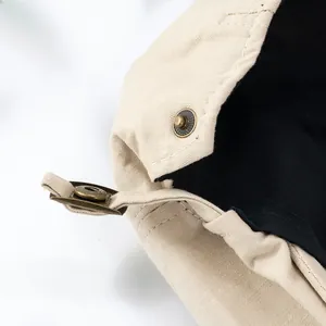 Detail of vintage copper buckle and beige cotton fabric on a Japanese beret cap