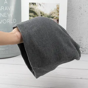 Close-up of a grey waffle knit beanie showing soft texture and breathable ribbed design