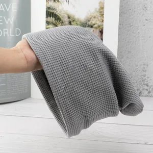 Detailed view of grey waffle knit beanie showing soft texture and elastic material