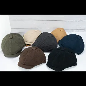 Vintage cotton newsboy caps in seven solid colors displayed on a white surface