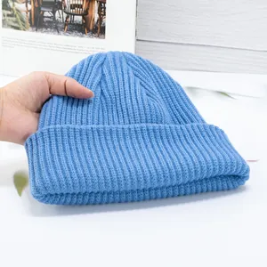 Detail view of the thick vertical knit texture and soft blue wool blend of this beanie hat