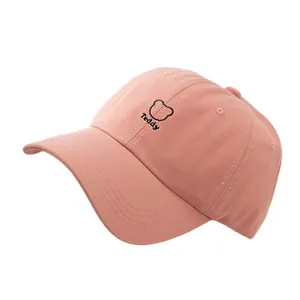 Pink cotton baseball cap featuring black teddy bear and text embroidery with curved brim