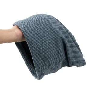 Dark grey waffle knit slouchy beanie for men and women showing thick soft fabric texture