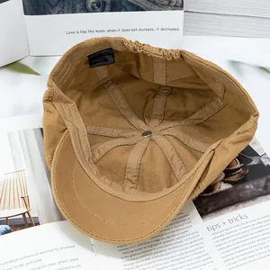 Detailed interior of khaki cotton newsboy cap showing quality lining and wash label