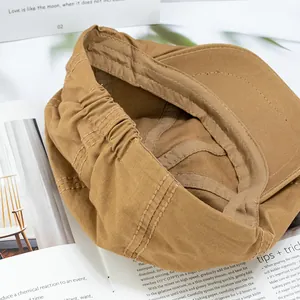 Classic khaki cotton newsboy cap featuring detailed interior lining and elastic fit