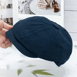 Close-up of navy cotton docker hat showing twill texture and six-panel stitching