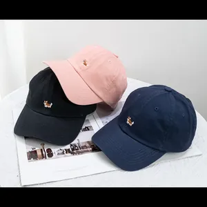 Detailed embroidery of Corgi dog on cotton baseball caps in pink, black, and navy blue