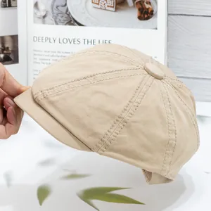 Detail of classic beige cotton newsboy cap showing textured fabric and stitching