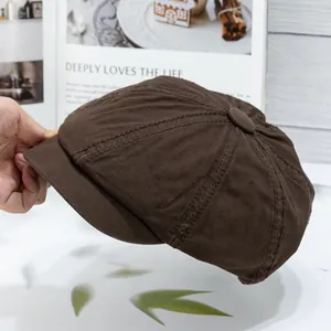 Detail shot of a dark brown newsboy cap with premium stitching and button top