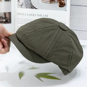 Detailed side view of military green cotton newsboy cap showing durable double-stitch seams