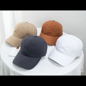 Classic cotton baseball caps in khaki, brown, charcoal, and white with curved brims