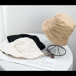 Detail of pleated texture and multiple color options for minimalist cotton bucket hats