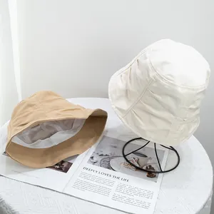 Detail of cotton bucket hats with breathable mesh lining and minimalist aesthetic