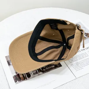 Inside view of khaki cotton baseball cap showing sweatband and adjustable buckle