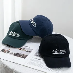 Three baseball caps in navy, green, and black with Andyou embroidery on a white table