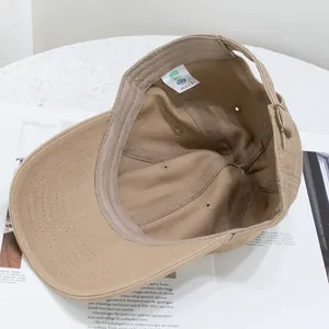Quality washed cotton baseball cap in khaki with interior certification label and metal buckle