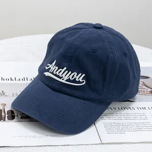 Detailed embroidery of white letters on a navy cotton twill casual baseball cap