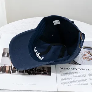 Navy blue cotton baseball cap interior view with metal adjustment buckle and logo detail