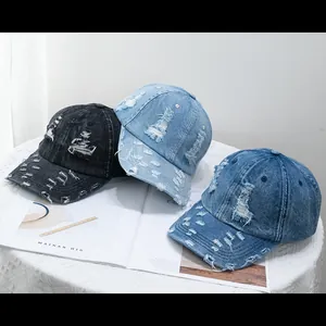 Detailed view of distressed denim baseball caps with frayed holes in three vintage colors
