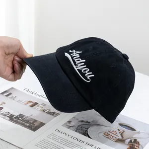 Detail of white Andyou embroidery on a premium black cotton canvas baseball cap