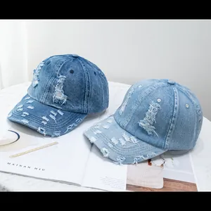 Vintage distressed washed denim baseball caps in blue and light blue with ripped details