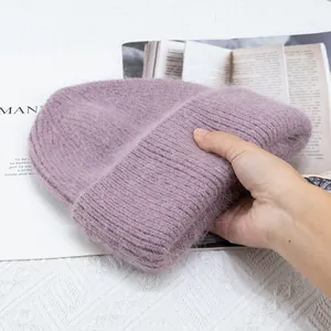 Primer plano del gorro de punto violeta de pelo de conejo con textura suave y elástica