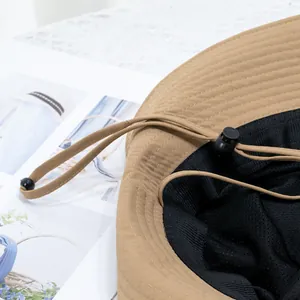 Detail of khaki sun hat featuring breathable mesh lining and adjustable windproof strap