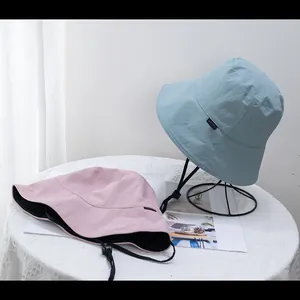 Double-sided wide brim sun hat for women with adjustable windproof cord in pink and blue