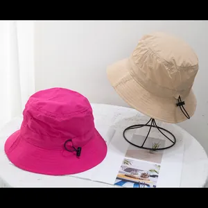 Detail of adjustable drawstring and toggle on lightweight quick-dry bucket hats