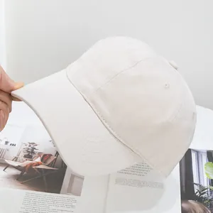 Detailed view of the premium cotton washed baseball cap in a soft cream beige color