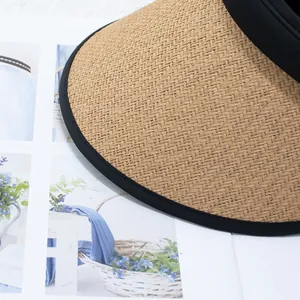 Detail of the woven straw visor texture and black fabric trim on this UV sun hat