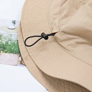 Detail of adjustable drawstring and buckle on breathable outdoor bucket hat