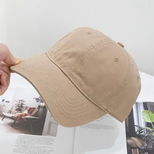 Close-up of khaki cotton baseball cap with reinforced stitching on a curved brim