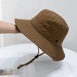 Detail of a brown outdoor sun hat with adjustable drawstring and parallel stitching