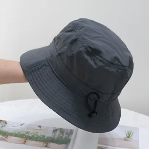 Detail of gray quick-dry bucket hat featuring adjustable drawstring toggle and stitching