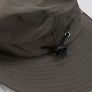 Detailed macro view of military green sun hat with metal eyelets and adjustable drawcord