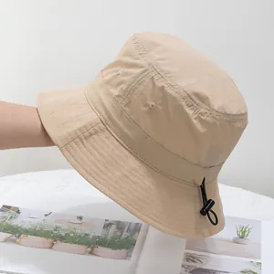 Detail of khaki bucket hat featuring quick-dry fabric and adjustable drawcord toggle