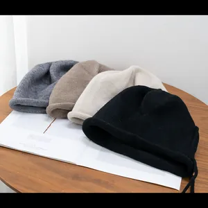 Unisex knit beanie collection in charcoal, camel, beige, and black with rolled edges