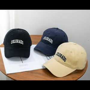 Detailed close-up of Colorado embroidery on three assorted cotton baseball caps
