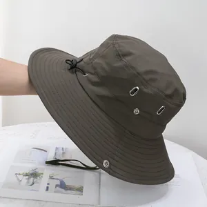 Detail of adjustable windproof drawstring and metal air vents on olive sun hat